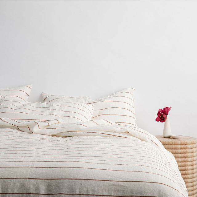 A bed dressed in Cedar Stripe bed linen. Available in Single, Double, King.