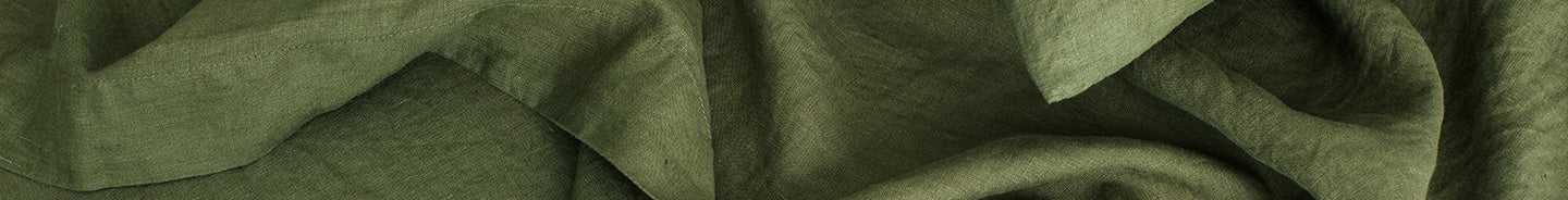 Bed made with linen bedding in Forest colour