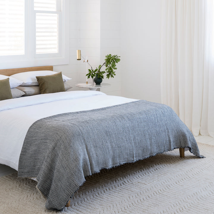 A bed dressed in a Linen Duvet Cover with a Mira Ellis throw. Available in Double, King, Super King.
