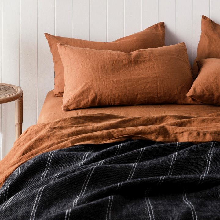 A bed dressed in Cedar bed linen, styled with a Mira Linen Bedcover in Rafa. Available in Double, King, Super King.