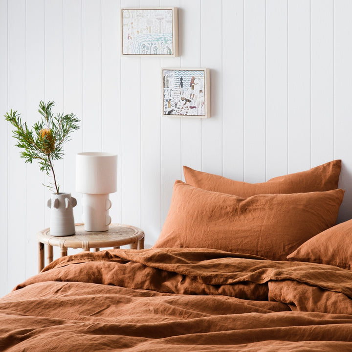 A bed dressed in Cedar bed linen, styled with a bamboo bedside table. Available in Single, Double, King & Super King.