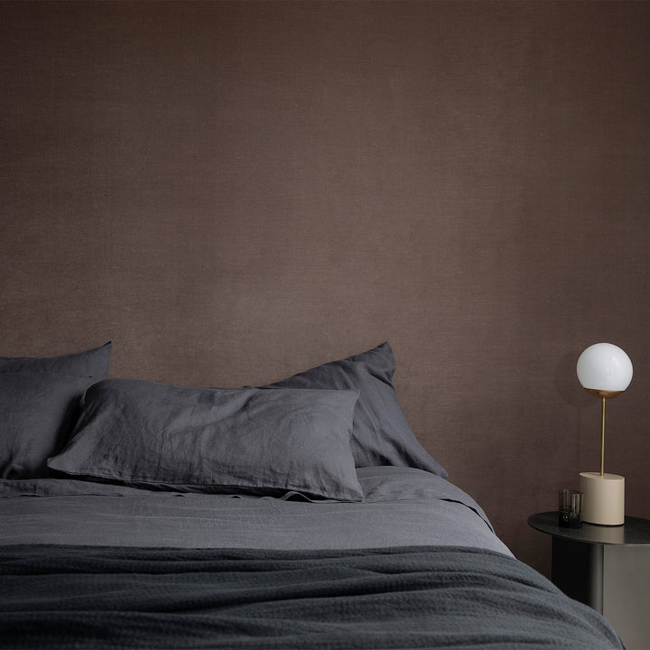 A bed dressed in Slate Linen bedding.