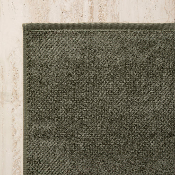 A close up of the corner of a Bath Mat in Forest