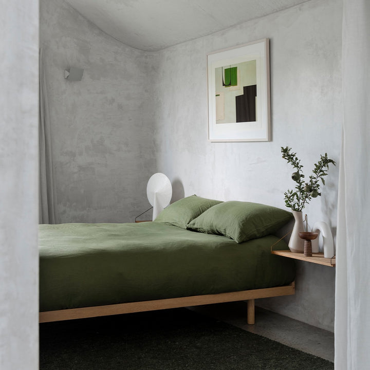 A bed dressed in Forest bed linen, styled with modern artwork and greenery. Available in Double, King, Super King.