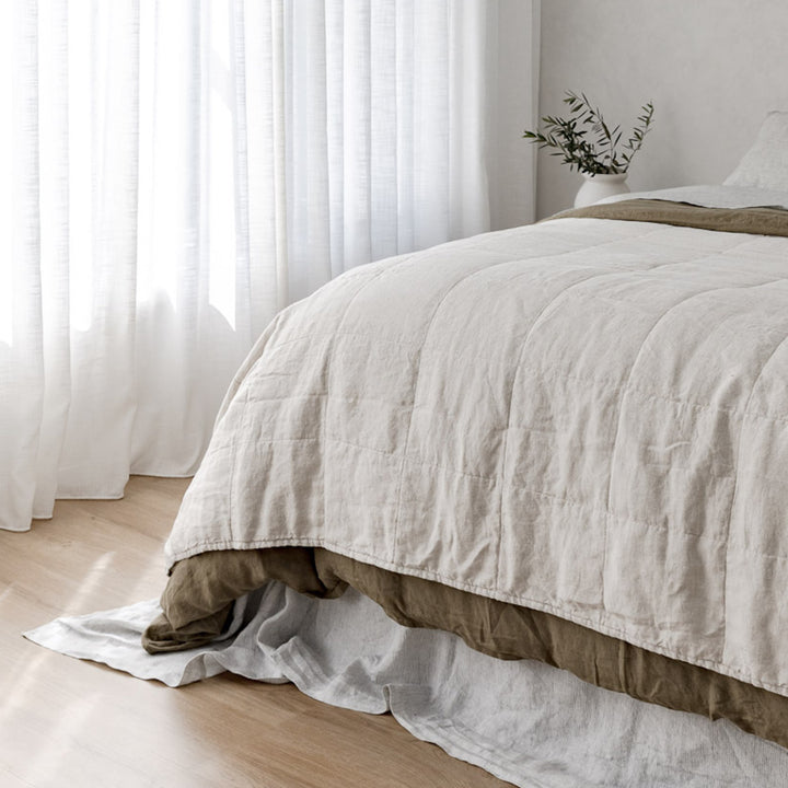 A cropped photo of a bed dressed in Olive, Natural and Pinstripe bed linen. Available in Double, King, Super King.
