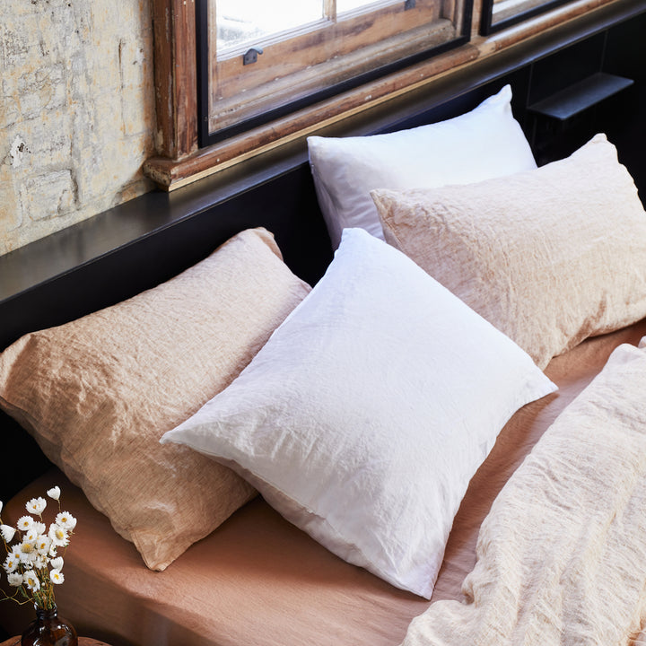 A bed dressed with White and Cinnamon Pillowcases, on a Fawn Fitted Sheet. Available in Standard & King.