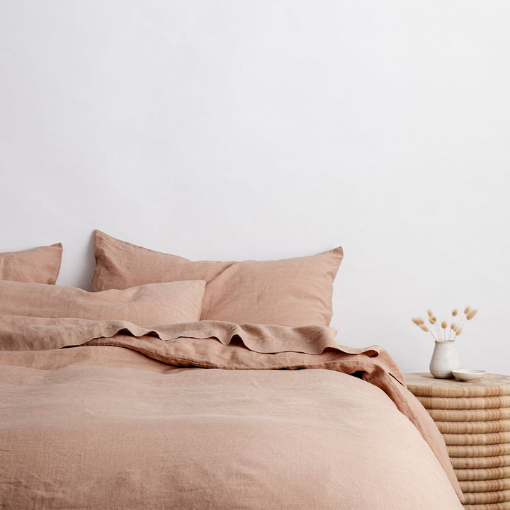 A bed styled with Fawn linen bedding