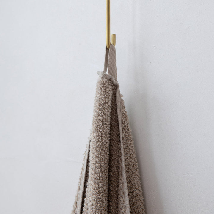 A close up on the hanging loop that can be used to hang the Pure Linen Bath Towel in Natural when drying.